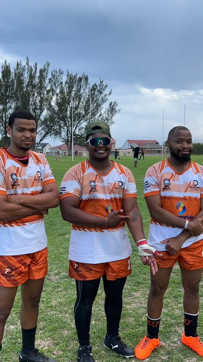 Three Olutsha Wolves players in orange and black kit